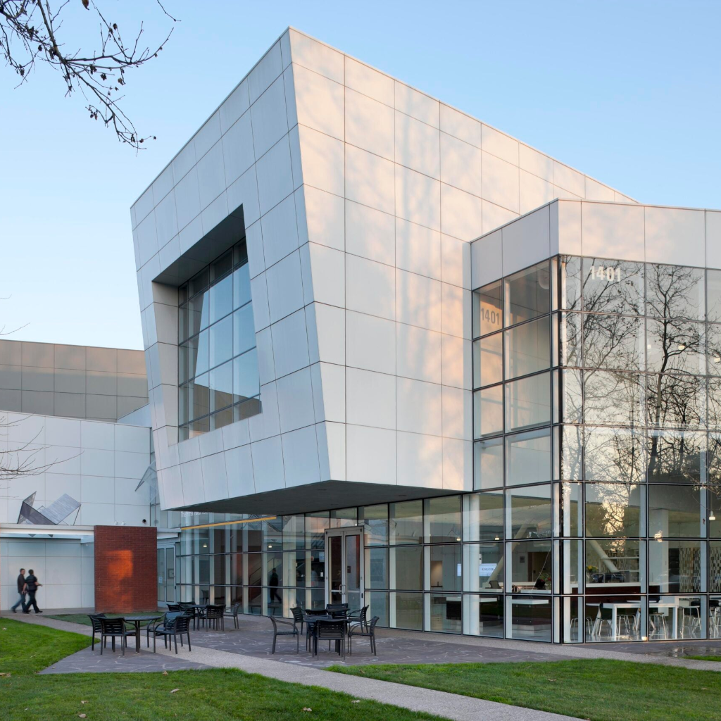 Modern glass building with a clear sky background
