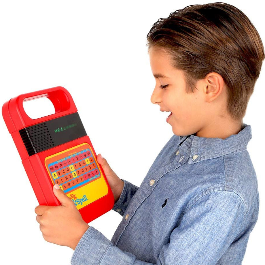 Child holding a red toy electronic device with colorful buttons on a white background